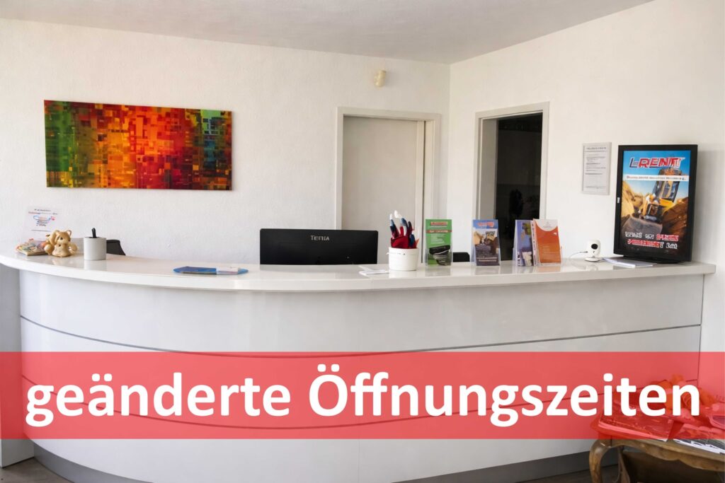 Empfangstheke in einem modernen Büro mit dem Hinweis „geänderte Öffnungszeiten“ im Vordergrund.